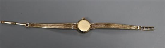 A ladys 1960s 9ct gold Tissot wristwatch on integral tapered bracelet, total 15.9g.
